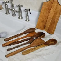 Sendok dan spatula kayu serta talenan kayu di dekat wastafel dapur setelah dicuci dan dikeringkan