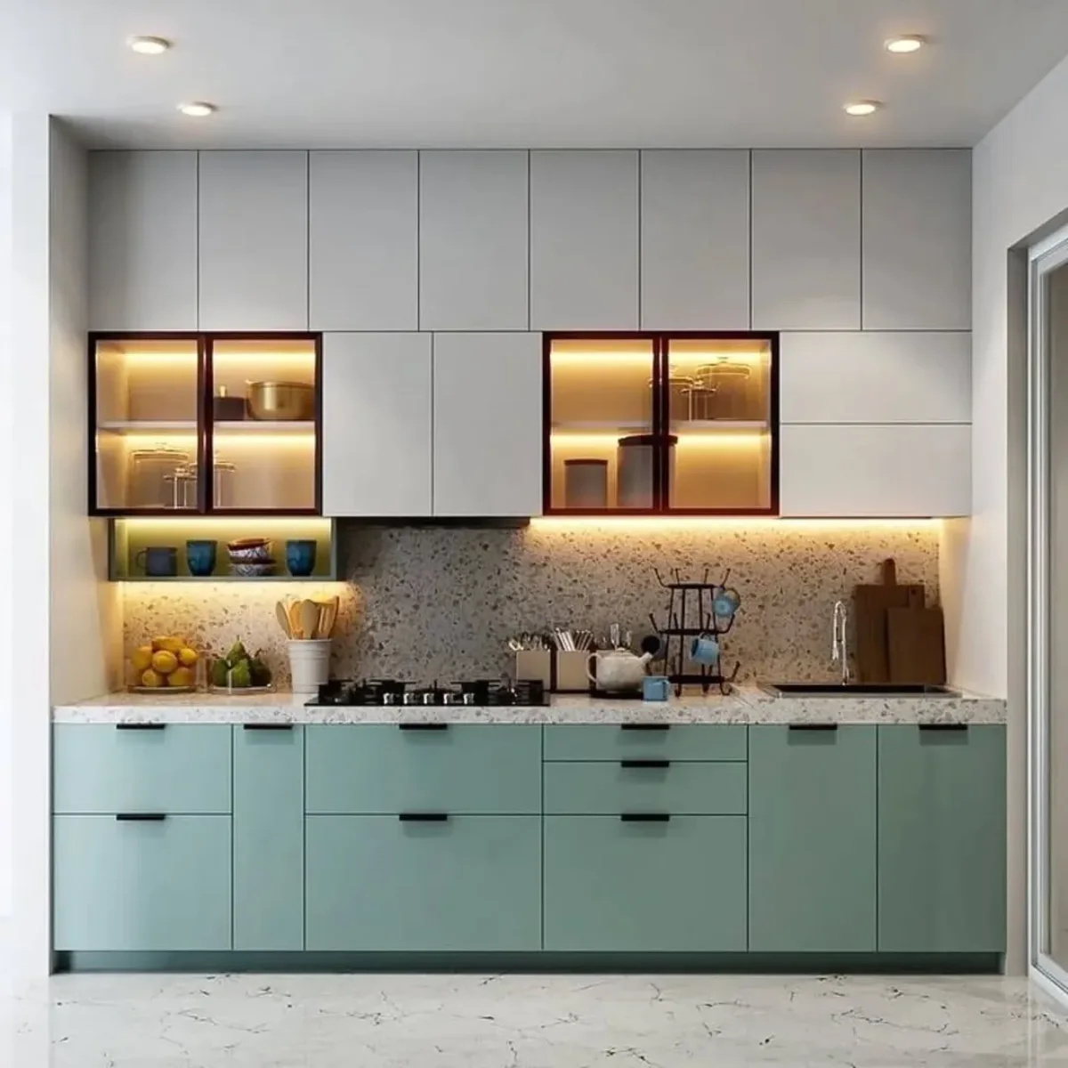 Desain dapur minimalis modern two-tone dengan kabinet bawah warna hijau teal pastel matte, kabinet atas putih, dan backsplash teraso estetik.