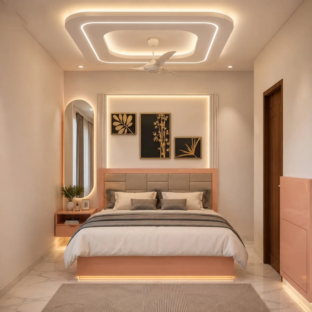 Kamar tidur nuansa peach lembut dengan tempat tidur berwarna senada, hiasan dinding bertema tanaman, cermin oval tinggi, dan pencahayaan plafon modern yang hangat.