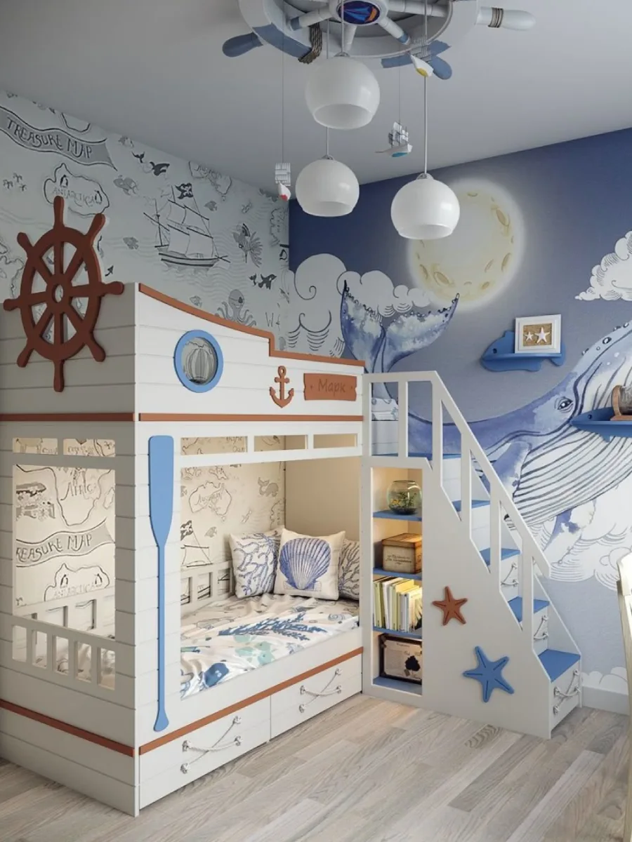 Interior kamar tidur anak bertema bajak laut dengan tempat tidur susun putih dan kayu yang kreatif, mural dinding paus dan bulan purnama, wallpaper peta harta karun, serta lampu gantung berbentuk roda kemudi kapal.