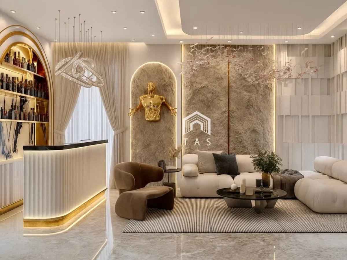 Ruang keluarga mewah bergaya modern dengan sofa krem berbentuk melengkung, dinding tekstur batu bernuansa netral, pencahayaan ambient hangat, dan area bar elegan di sudut ruangan.