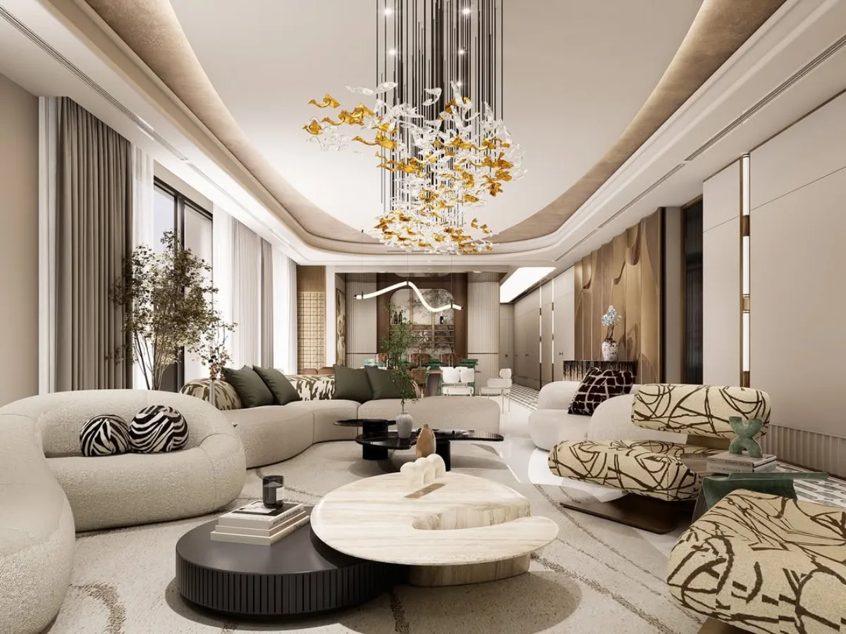 Perspektif sudut lebar dari ruang tamu mewah yang menggabungkan furnitur berbentuk organik dan elemen seni. Kursi santai dengan motif garis-garis abstrak dan sofa melingkar empuk mengelilingi meja kopi marmer berlapis. Cahaya alami masuk melalui jendela besar dengan gorden abu-abu yang menjuntai. Desain langit-langit yang dinamis dengan lampu gantung artistik berwarna emas memberikan kesan megah pada ruang keluarga bertema modern kontemporer ini.