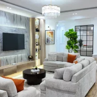 Desain ruang keluarga modern minimalis dengan sofa abu-abu, meja bundar hitam, panel TV marmer, dan pencahayaan hangat yang rapi.