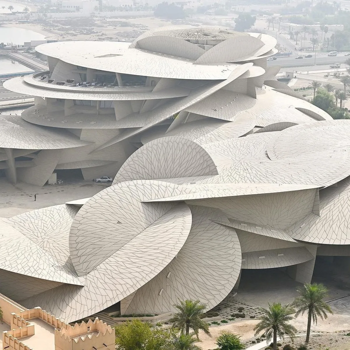 struktur National Museum of Qatar yang terdiri dari cakram-cakram putih tumpang tindih, tampak seperti mawar gurun yang besar