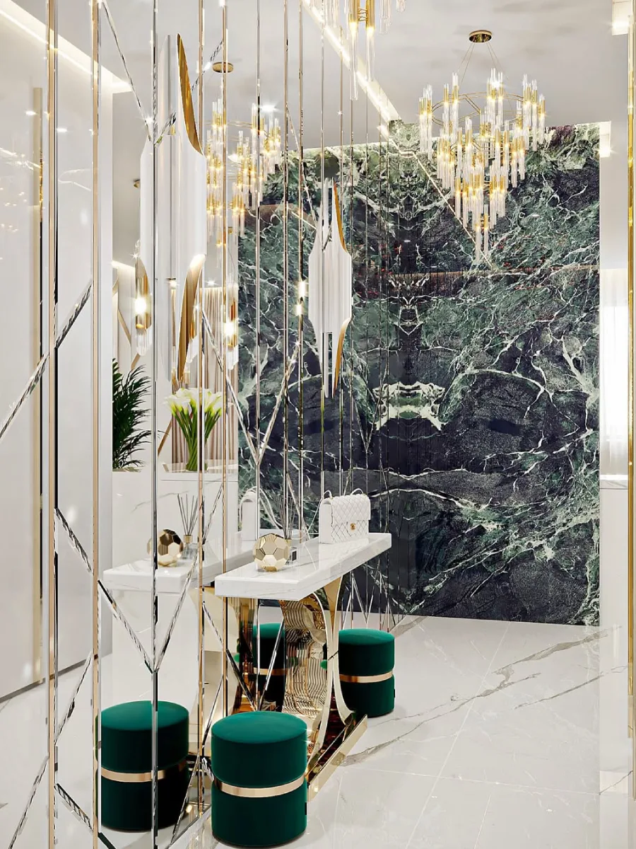 Koridor masuk mewah dengan meja konsol marmer, pouf beludru hijau zamrud, layar pembatas geometris, dan lampu gantung kristal emas.