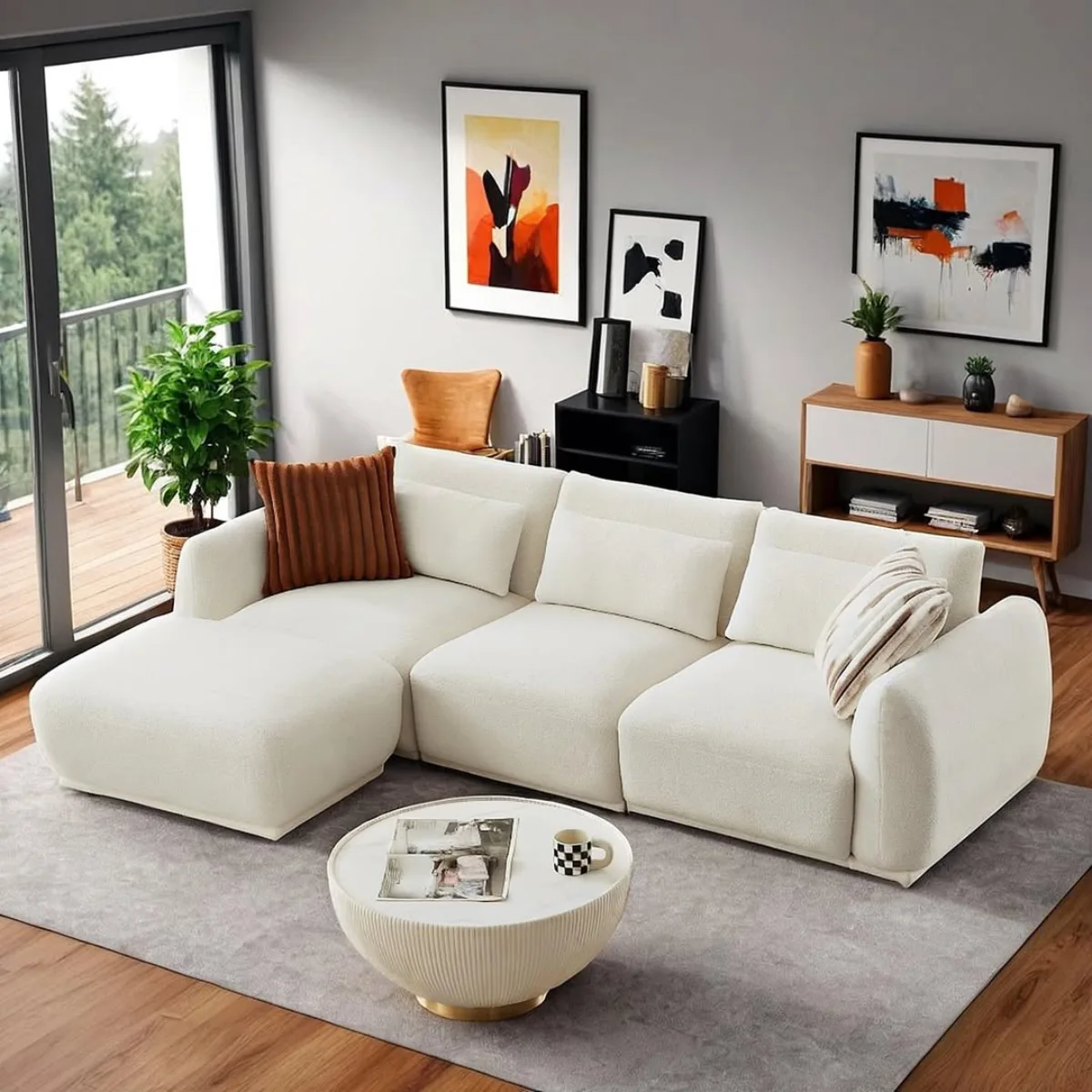 Sofa modular L-shape warna putih gading dengan desain low profile yang empuk dan modern di ruang tamu minimalis dengan pencahayaan alami. Cocok untuk bagian artikel yang membahas: Sectional Sofa atau Sofa Minimalis Modern.