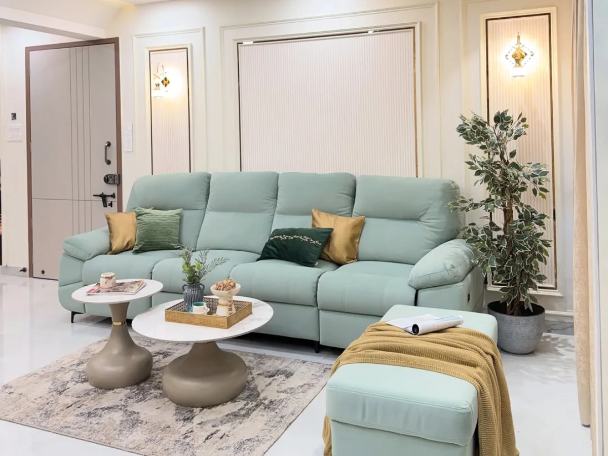 Ruang tamu estetik dengan sofa hijau pastel, karpet modern, dan dekorasi minimalis