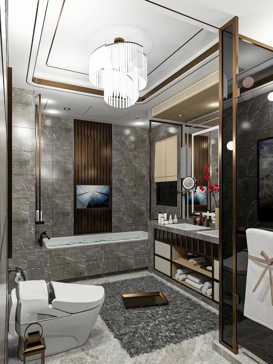 Kamar mandi utama bergaya glamor dengan lantai dan dinding marmer abu-abu tua, bathtub tanam dengan layar TV dinding di atasnya, serta lampu gantung kristal besar yang mewah di tengah ruangan.