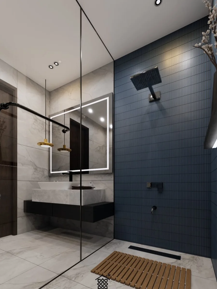 Area wastafel modern dengan kabinet hitam melayang, cermin persegi dengan lampu LED terintegrasi, lampu gantung emas, dan lantai kayu kisi-kisi di area basah.